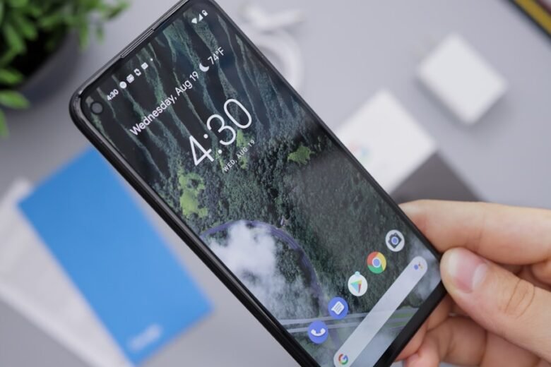 Android smartphone held in hand for Pixel security update article. Photo by Daniel Romero on Unsplash.