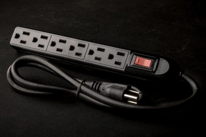 Black multi-outlet power strip resting on a table