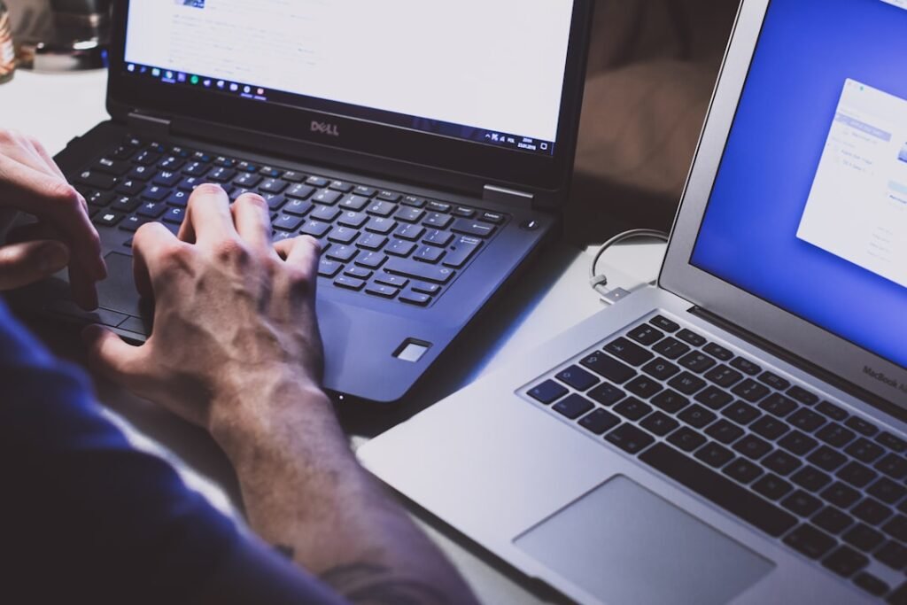 Person using a laptop for browser extension safety guide. Photo by freestocks on Unsplash.