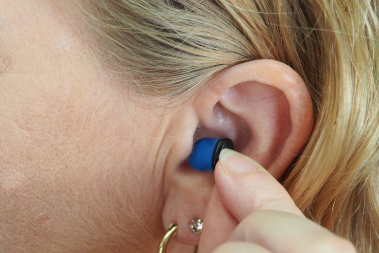Ear and earring close-up illustrating an earbud fit and comfort test