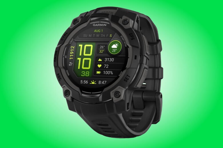 Garmin Instinct 3 AMOLED product image with a black case and strap against a green background