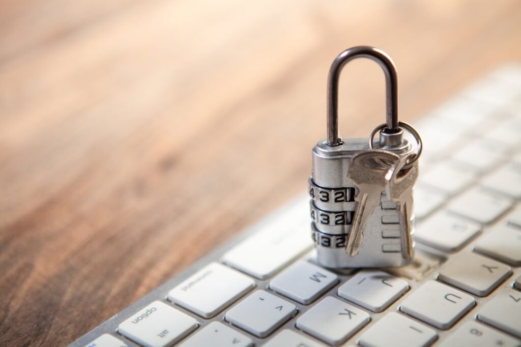 Padlock resting on a laptop keyboard as a data-security illustration