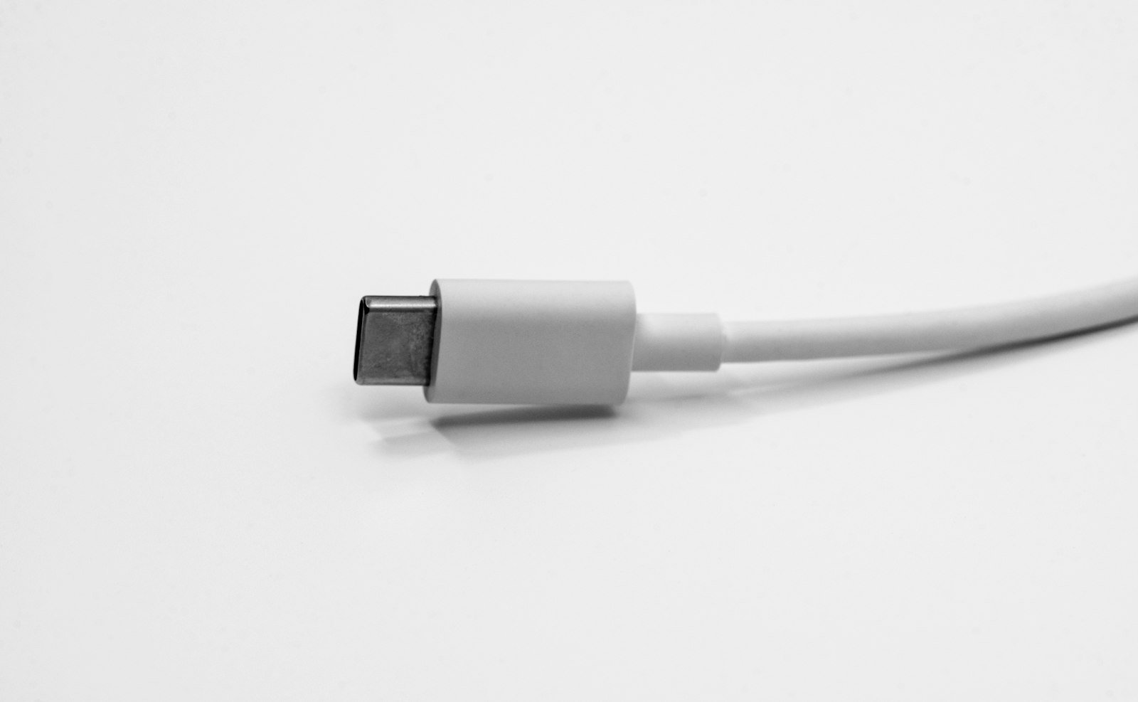 White USB-C cable arranged on a light surface