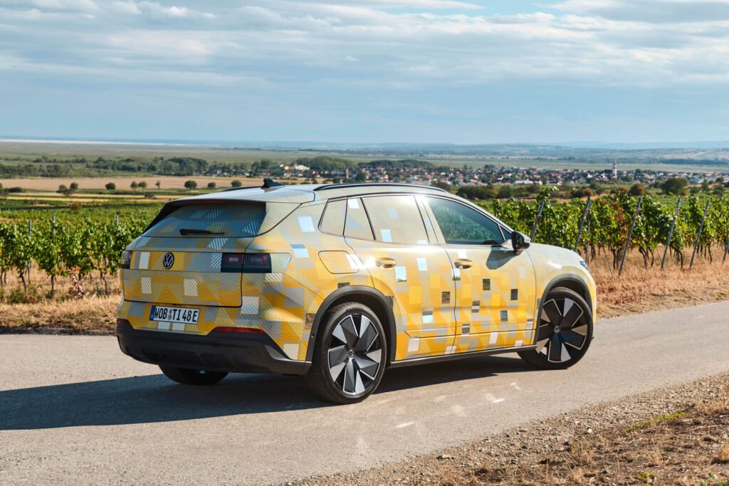Camouflaged near-production Volkswagen ID. Tiguan electric SUV on a country road