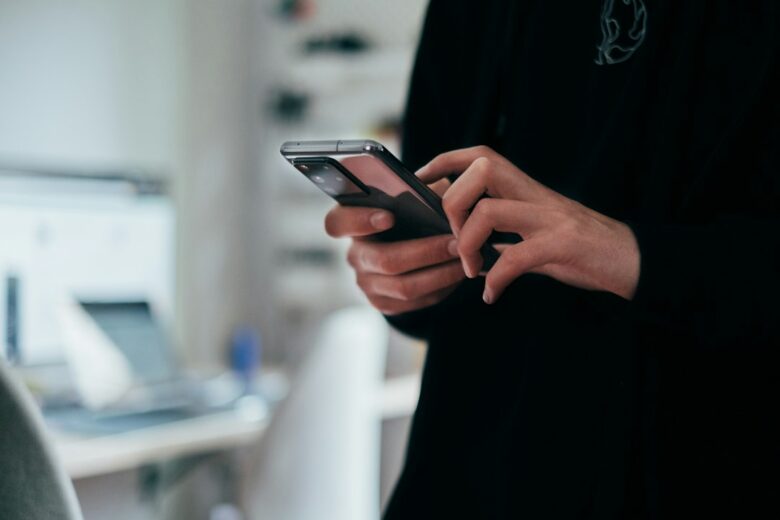 Person using an Android smartphone before installing a security update. Photo by Jonas Leupe via Unsplash.