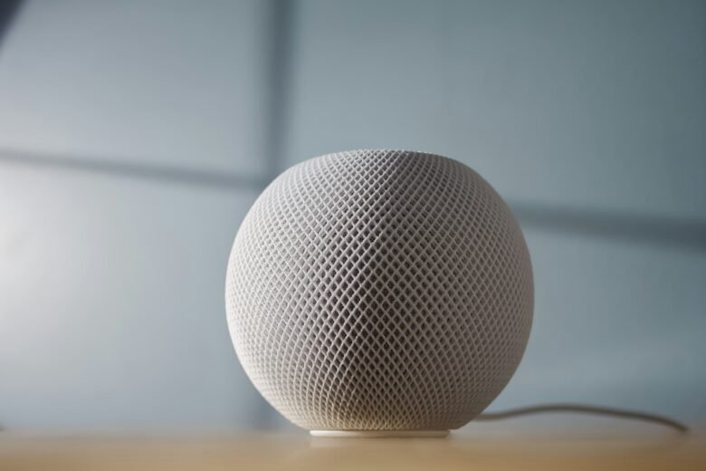 White Apple HomePod mini smart speaker on a tabletop