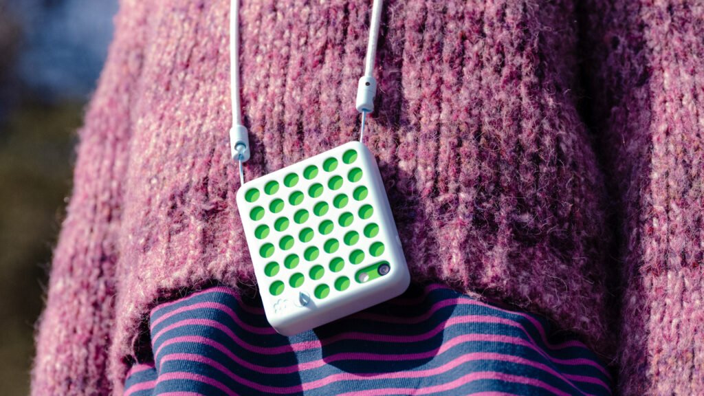 A child wearing a blue Freckle phone on a lanyard outdoors. Image: Freckle Technologies.
