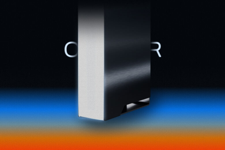 Ghost Core personal AI computer, a compact black and silver tower, shown against a dark background with blue and orange light. Image: Ghost.
