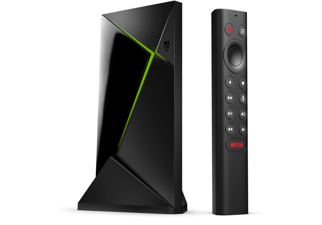 NVIDIA Shield TV Pro streaming box beside its triangular remote on a white background