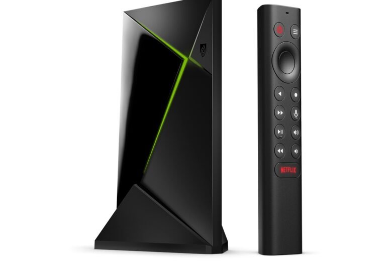 NVIDIA Shield TV Pro streaming box beside its triangular remote on a white background