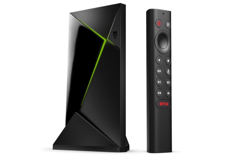 Black Nvidia Shield TV Pro streaming box standing beside its triangular remote control