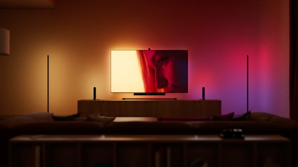 Television room illuminated with synchronized Philips Hue gradient lighting in red, amber and purple