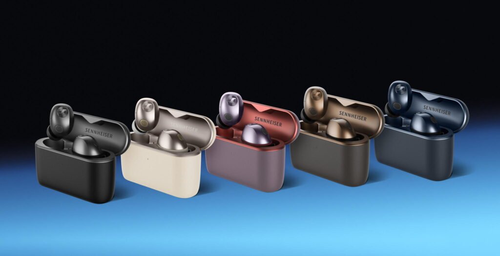 Five pairs of Sennheiser Momentum True Wireless 5 earbuds in open charging cases