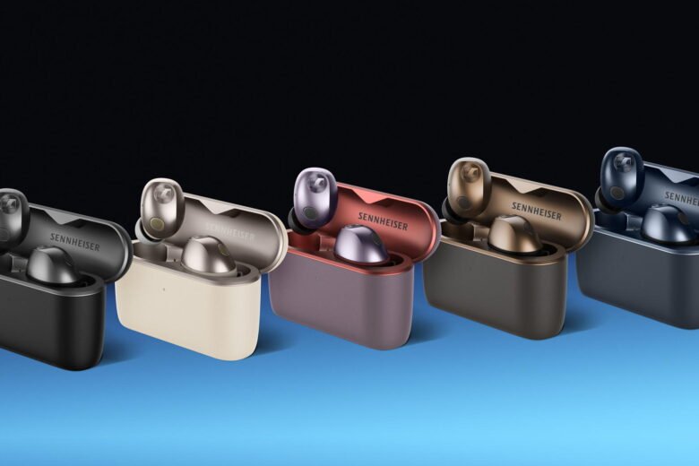 Five pairs of Sennheiser Momentum True Wireless 5 earbuds in open charging cases