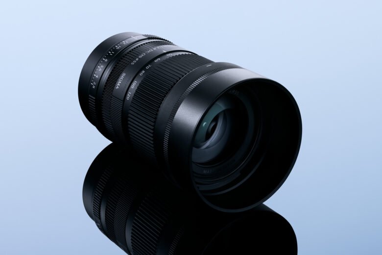 Sigma 50-120mm F2.8 DC OS Contemporary APS-C telephoto zoom lens on a blue studio background