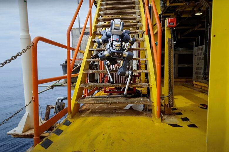 ANYmal X four-legged inspection robot walking down industrial stairs on an offshore platform