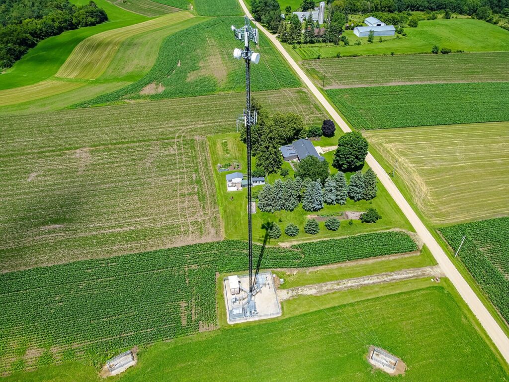 Cellular tower under an open sky, representing terrestrial infrastructure for satellite-to-phone service