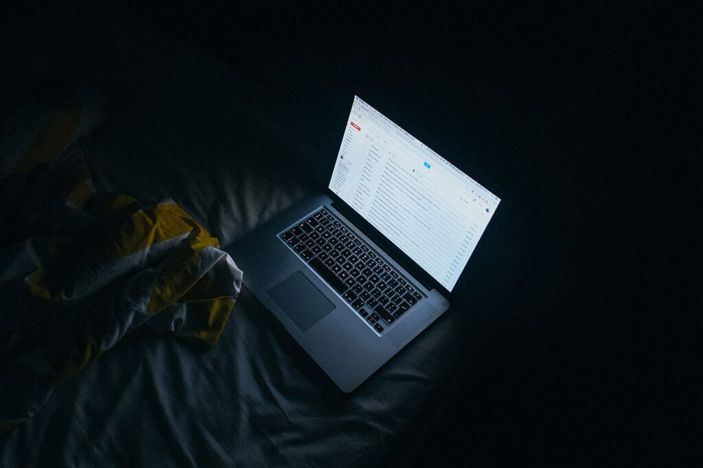 Gmail open on a laptop in a dark room, illustrating Google Personal Intelligence privacy settings