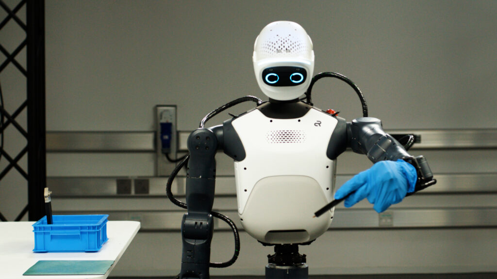 Humanoid robot wearing a blue glove in a robotics lab, illustrating NVIDIA Isaac platform development