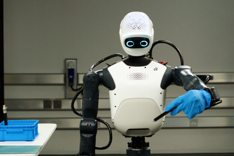 Humanoid robot wearing a blue glove in a robotics lab, illustrating NVIDIA Isaac platform development
