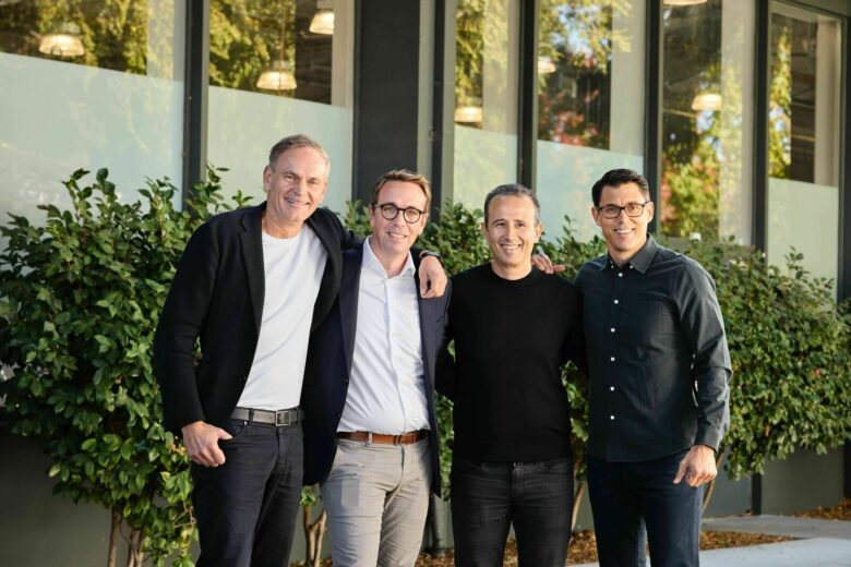 Rivian and Volkswagen leaders standing together at the joint venture launch