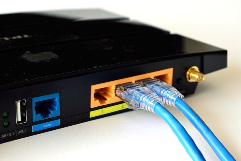 Close-up photograph of a home Wi-Fi router with wireless status indicators